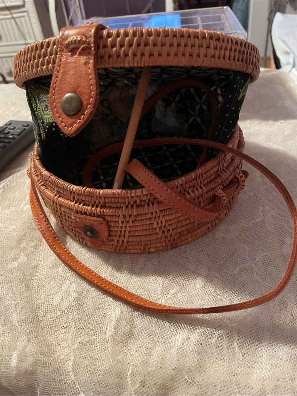 Hand woven, round rattan canteen bag with leather straps